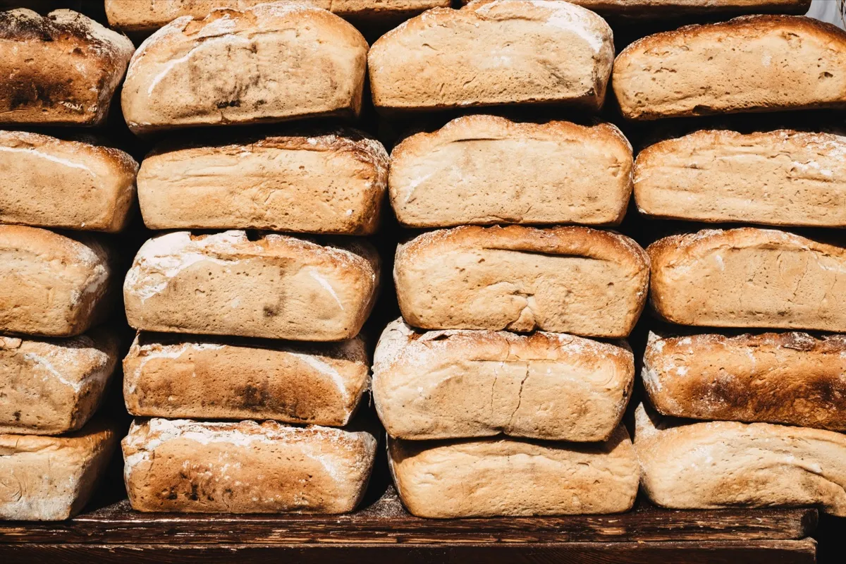 Loaves of bread stacked on a shelf